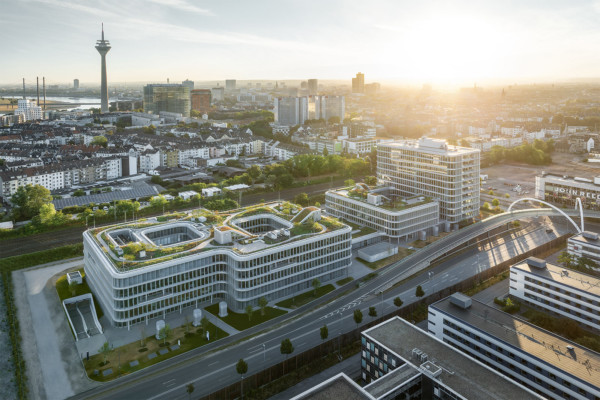 Visualisierung WPP Campus: Luftbild des WPP Headquarters Mizal in Düsseldorf. Es besteht aus zwei Gebäuden, die im ersten Stock miteinander verbunden sind. Eines sieht aus wie eine liegende, eckige Acht. Das zweite besteht aus zwei Teilen: Ein vierstöckiger und ein elfstöckiger Teil