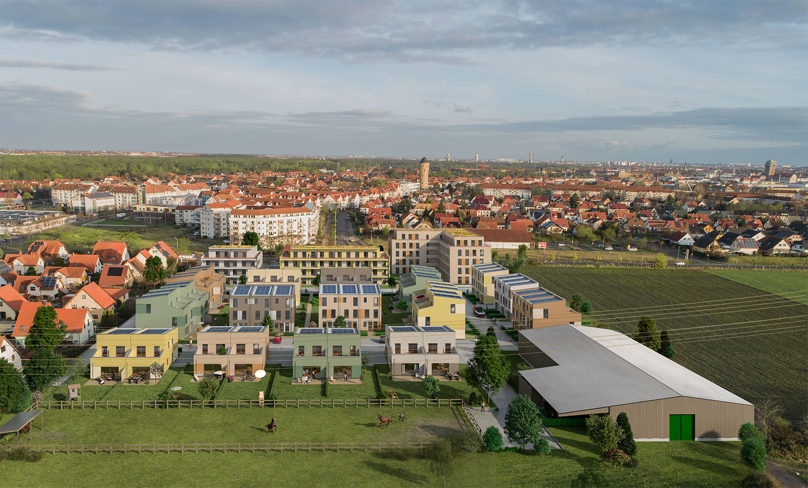 Quartier Schöner Land in Leipzig. Viele Mehrfamilienhäuser umgeben von Grün, im Hintergrund die Stadt.